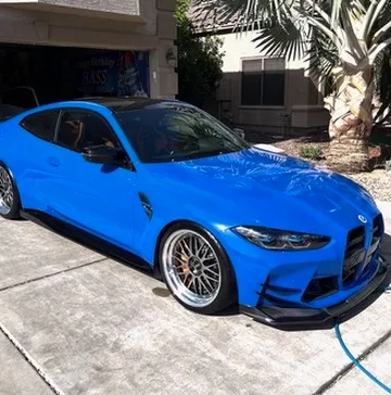 Front end of a detailed BMW with clear, bright headlights